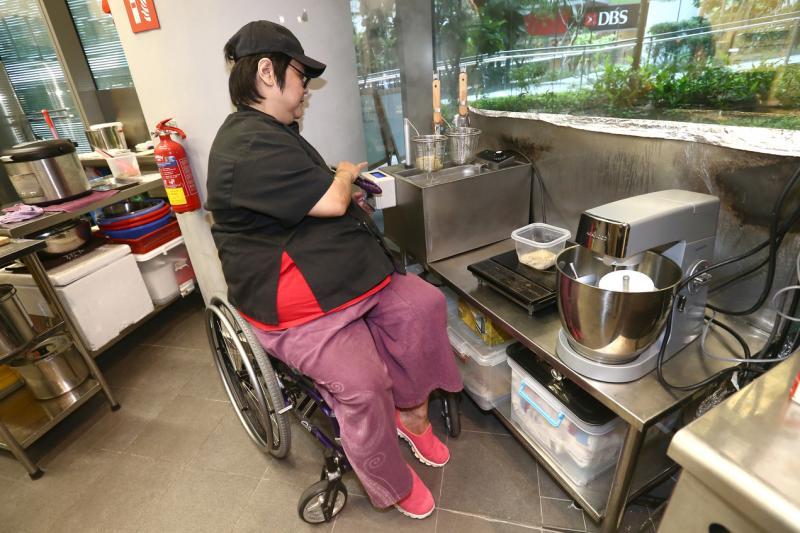 廚師何俐蓮坐在輪椅上用自動煮麵機烹煮意大利面。